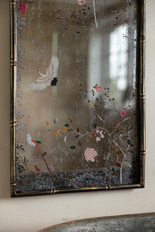 Close-up of the bottom of the Beautiful Pink Chinoiserie Decorative Mirror, styled on the wall above a bath.