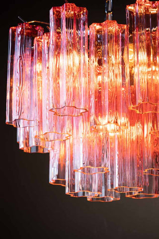 Detail shot of the Beautiful Waved Glass Chandelier in Pink switched on.