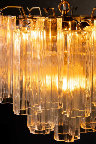 Detail shot of the Beautiful Waved Glass Chandelier in Clear switched on.