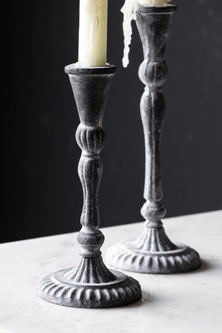 Close-up of the Short Black Antique Zinc Style Candlestick Holder, with the tall version in the background.