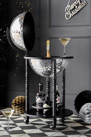 Silver disco ball drinks trolley thats open with glassware