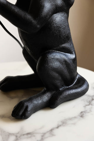 Close-up of the side of the Quirky Black Dog Lamp.