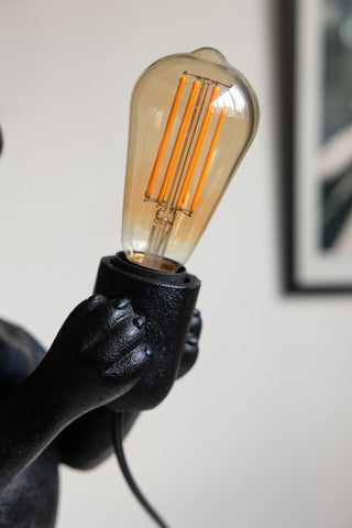 Close-up of a bulb in the Quirky Black Dog Lamp.