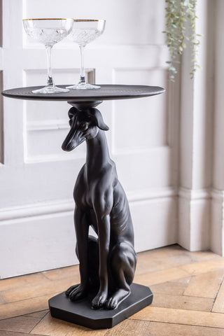The Black Greyhound Dog Side Table styled with two cocktail glasses on top.
