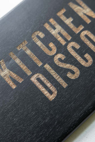 Close-up of the design of the Black Kitchen Disco Slim Serving Board.