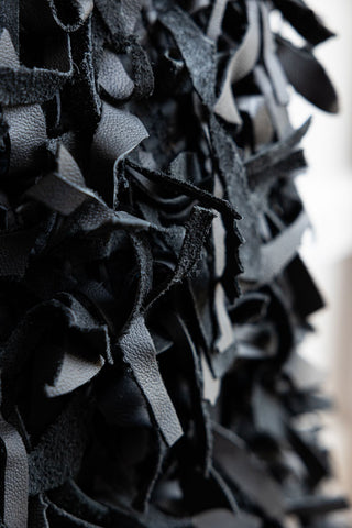 Close-up of the fringing on the Black Leather Cushion Cover.