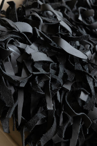 Close-up of the fringe design on the Black Leather Cushion Cover.