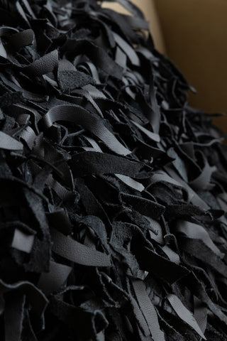 Detail shot of the fringe design on the Black Leather Cushion Cover.