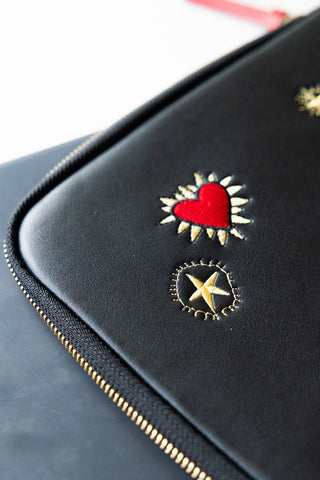 Detail shot of the motifs on the Black Milagro Heart Laptop Case.