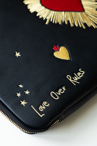 Close-up of the text on the Black Milagro Heart Laptop Case.