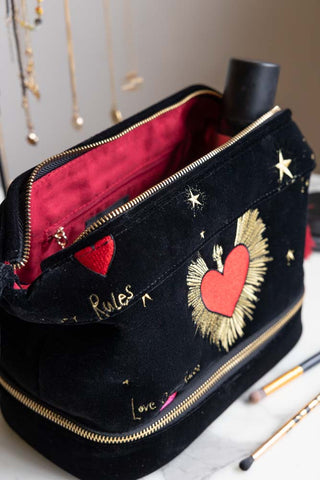 The Black Milagro Heart Velvet Wash Bag unzipped, styled with beauty accessories.