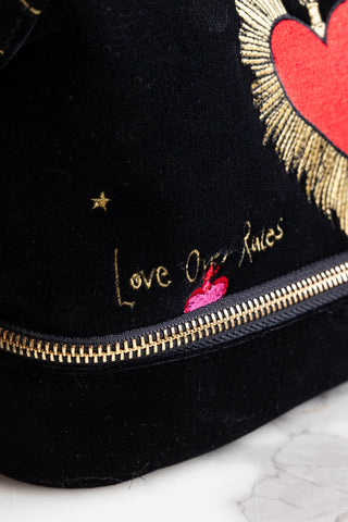 Detail shot of the text on the Black Milagro Heart Velvet Wash Bag.