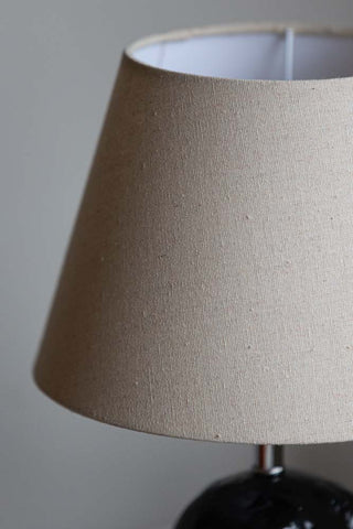 Close-up of the shade on the Black Seal Table Lamp With Linen Shade.