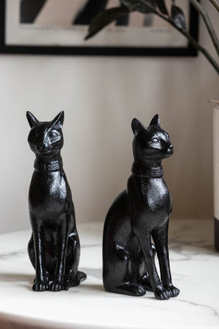 The Black Sitting Cat Bookends styled on a white table.