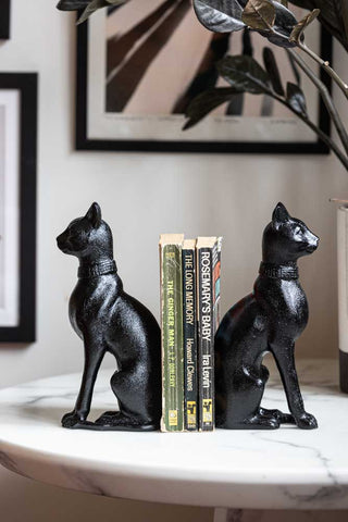 The Black Sitting Cat Bookends facing opposite directions styled with some books inbetween.