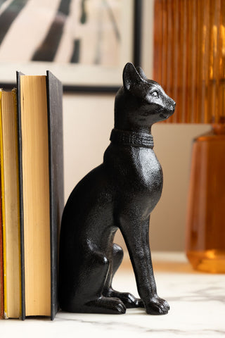 Detail of Black Sitting Cat Bookends with books and orange lamp