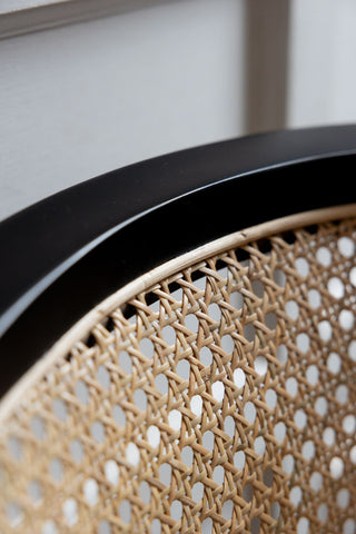 Close-up of the top of a wicker desk chair.