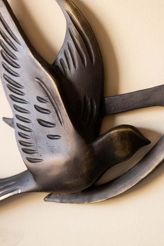 Close-up of one of the birds on the Antiqued Brass Effect Bird Wall Art.