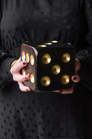 Image of the Black & Gold Dice Ornament held in hands.