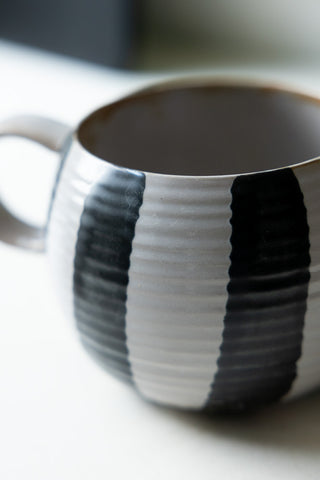 Close-up of the side of the Black & White Stripe Cuddle Mug.