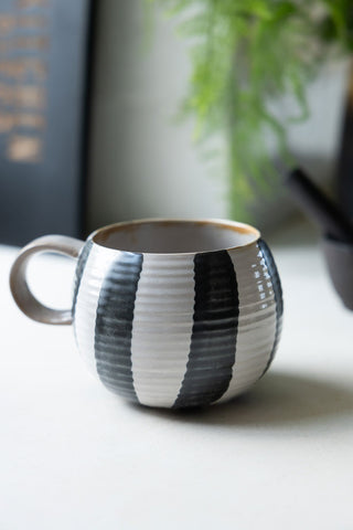 Black & White Stripe Cuddle Mug on a kitchen worktop.