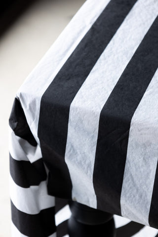 Detail shot of the Black & White Striped Tablecloth styled on a table.