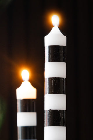 Close-up of two of the Black & White Striped Taper Candles - Pack Of 4.