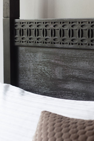 Close-up of the headboard of the Boho-Inspired Boutique Four Poster Bed.