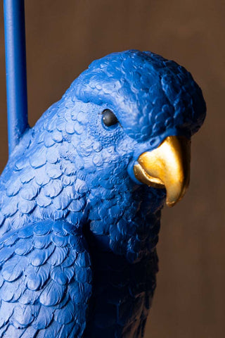 Detail shot of the face of the parrot on the Bold Blue Parrot Floor Lamp with Shade.