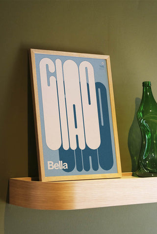 The Bold Ciao Bella Art Print in a frame, styled leaning against the wall on a shelf.