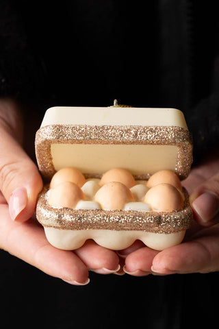 The Box Of Eggs Christmas Tree Decoration being held in a model's hands.