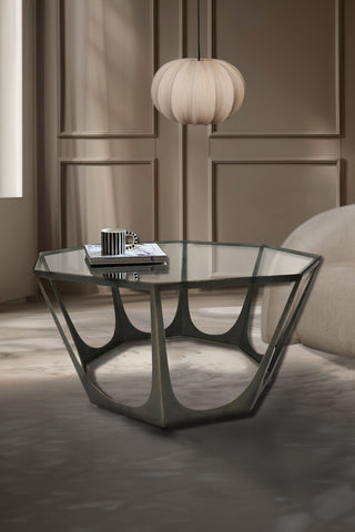 Bronze and glass octagonal coffee table styled with book and mug