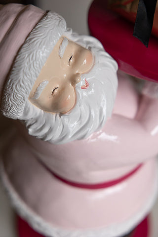 Close-up of the face of the Butler Santa In Pink Christmas Decoration, seen from above.