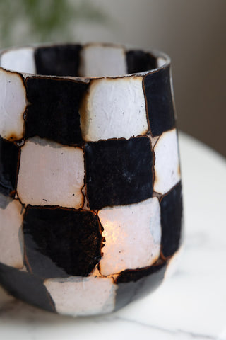 Close-up of the Checkered Black & White Glass Tealight Holder with a lit tealight inside.