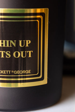 Detail shot of the design on the Chin Up, Tits Out Scented Candle.