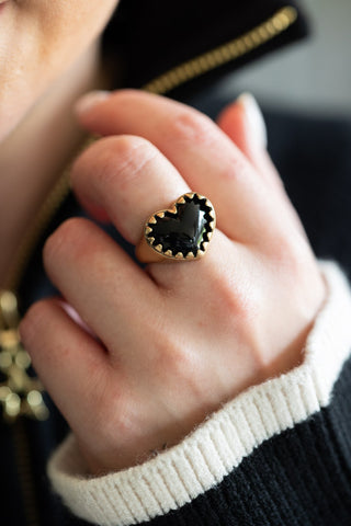 The Chunky Gold & Black Heart Ring being worn by a model.