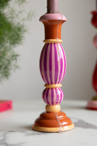 Close-up of the bottom of the Colourful Candlestick Holder in Pink Stripes with a drip of wax.