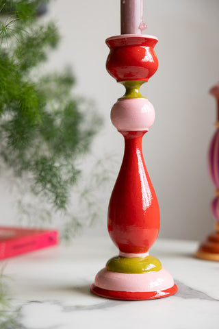 Close-up of the Colourful Candlestick Holder in Red & Pink styled on a white table.