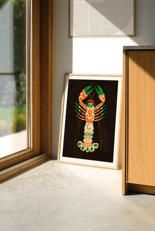 A lobster art print displayed against a wall.