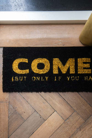 Close-up of the Come In (But Only If You Have Wine) Coir Doormat.