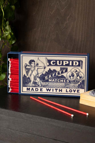 The Cupid, Made With Love Giant Luxury Matchbox open, with some of the matches loose on the table.