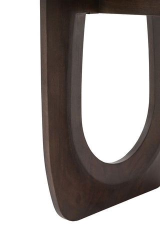 Detail shot of the leg of the Curved Mango Wood Dining Table on a white background.