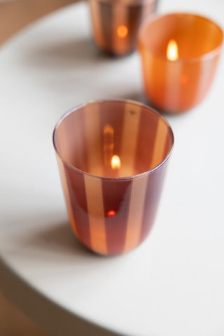 Close-up of the Deep Bordeaux Striped Tealight Holder - Tall with a lit tealight inside, seen from above.