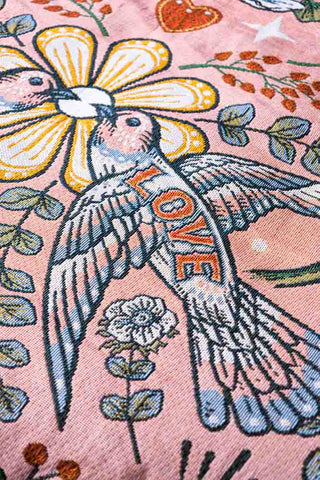 Detail shot of the bird motif on the Denim & Bone Blue Lovebirds Woven Cotton Throw.