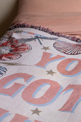 Close-up of the Denim & Bone You Got This Woven Cotton Throw styled on a bed.