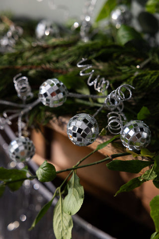 Close-up of the Disco Ball Clip on Christmas Decoration styled on a wooden fireplace.