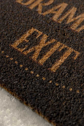 Close-up of the text on the Dramatic Exit Doormat.