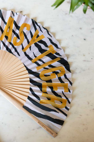 Close-up of the Easy Tiger Print Fan on a white marble table.