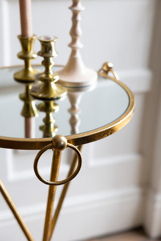 Detail shot of the Elegant Gold & Glass Side Table with candlesticks styled on the top.