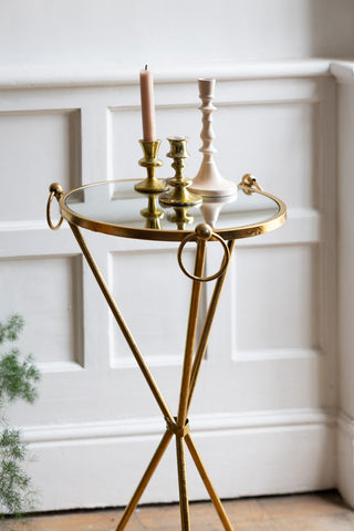 The Elegant Gold & Glass Side Table with three candlesticks styled on the top.